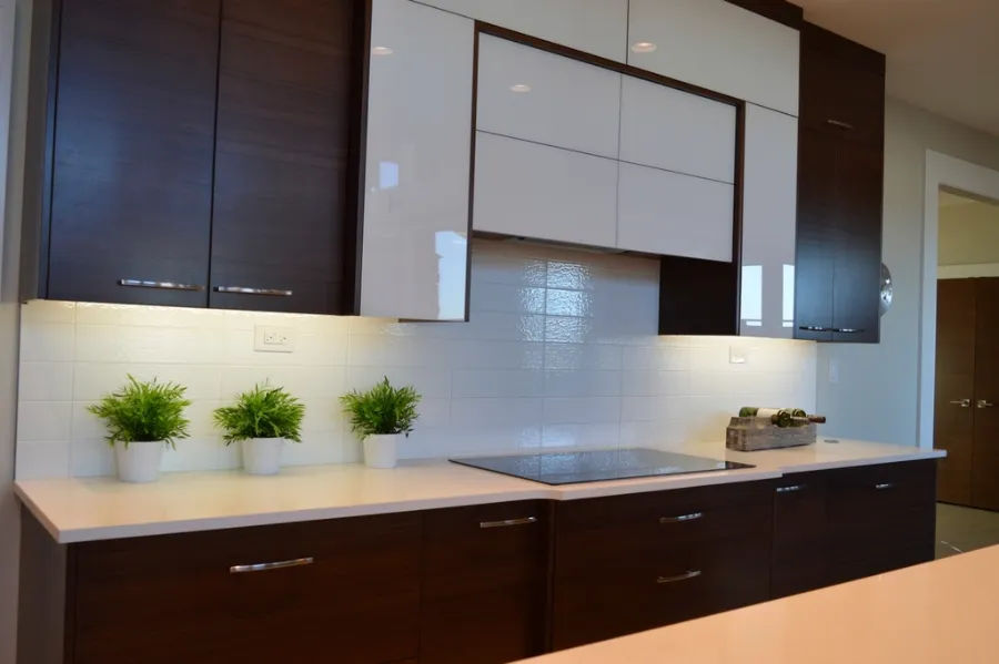 Remodeled kitchen with dark cabinetry and a tiled backsplash
