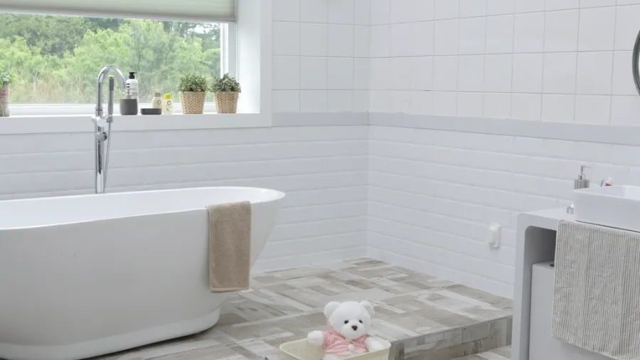 Guest bathroom with a freestanding soaking tub and subway tile in {{CITY}}