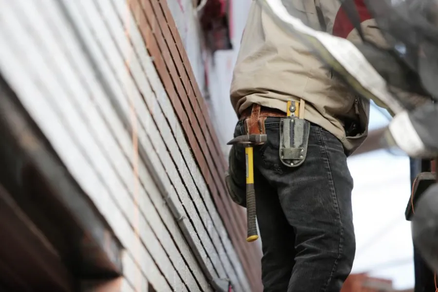 Carpenter with a tool belt on a Dothan job site